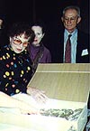 Lorna Scherzer examining ritual objects during the Prague Symposium, 1995